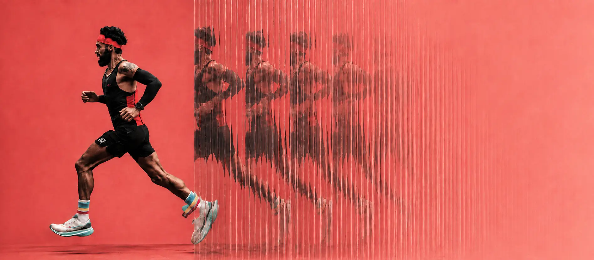A runner mid-stride against a red wall, his silhouette repeating through fluted glass